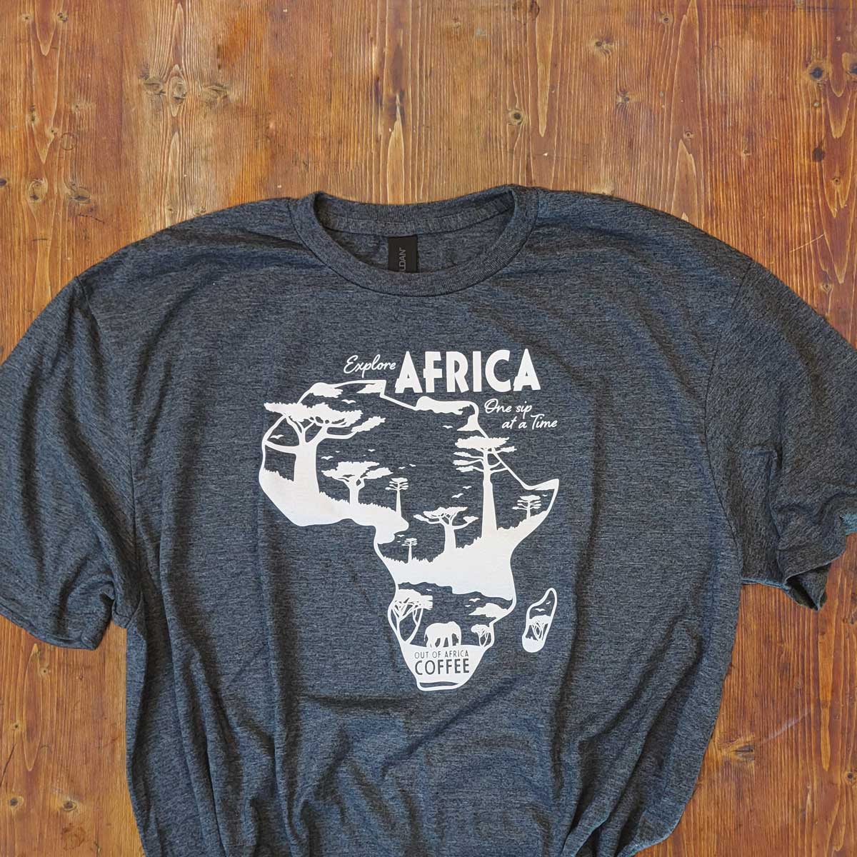 Heathered Grey T-Shirt with "Explore Africa One Sip at a Time" in white with African continent on the front